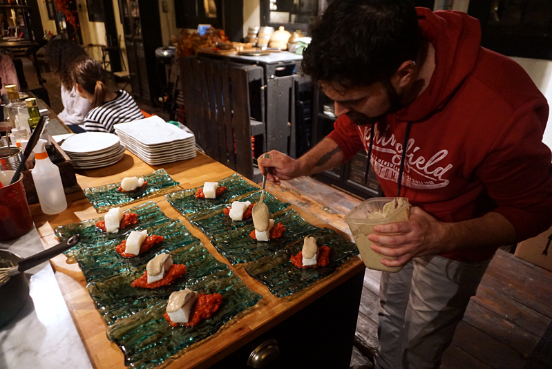Dining at Hidden Factory Barcelona: Xavi putting the finishing touches on the bacalao, the delicious salt cod dish that was inspired by the roof of Casa Battló on Passeig de Gracia